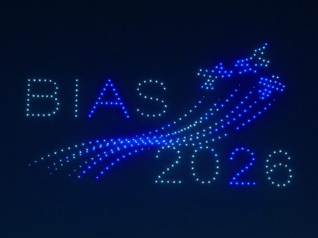 Drones spelling BIAS 2026 alongside an illuminated aircraft in the night sky, from the FLYSTACK drone show at the Bucharest International Air Show
