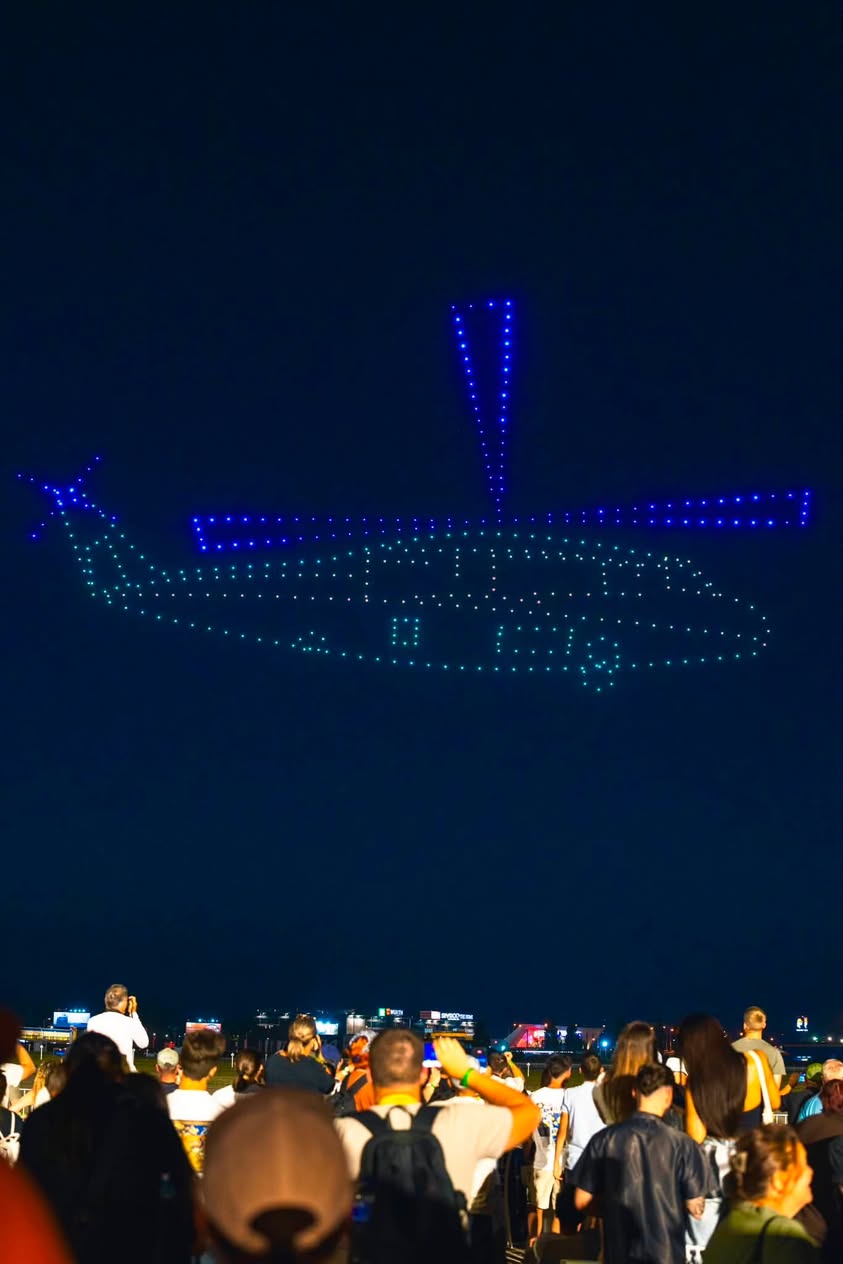 A helicopter outlined in drones against the night sky in the FLYSTACK show at BIAS 2026