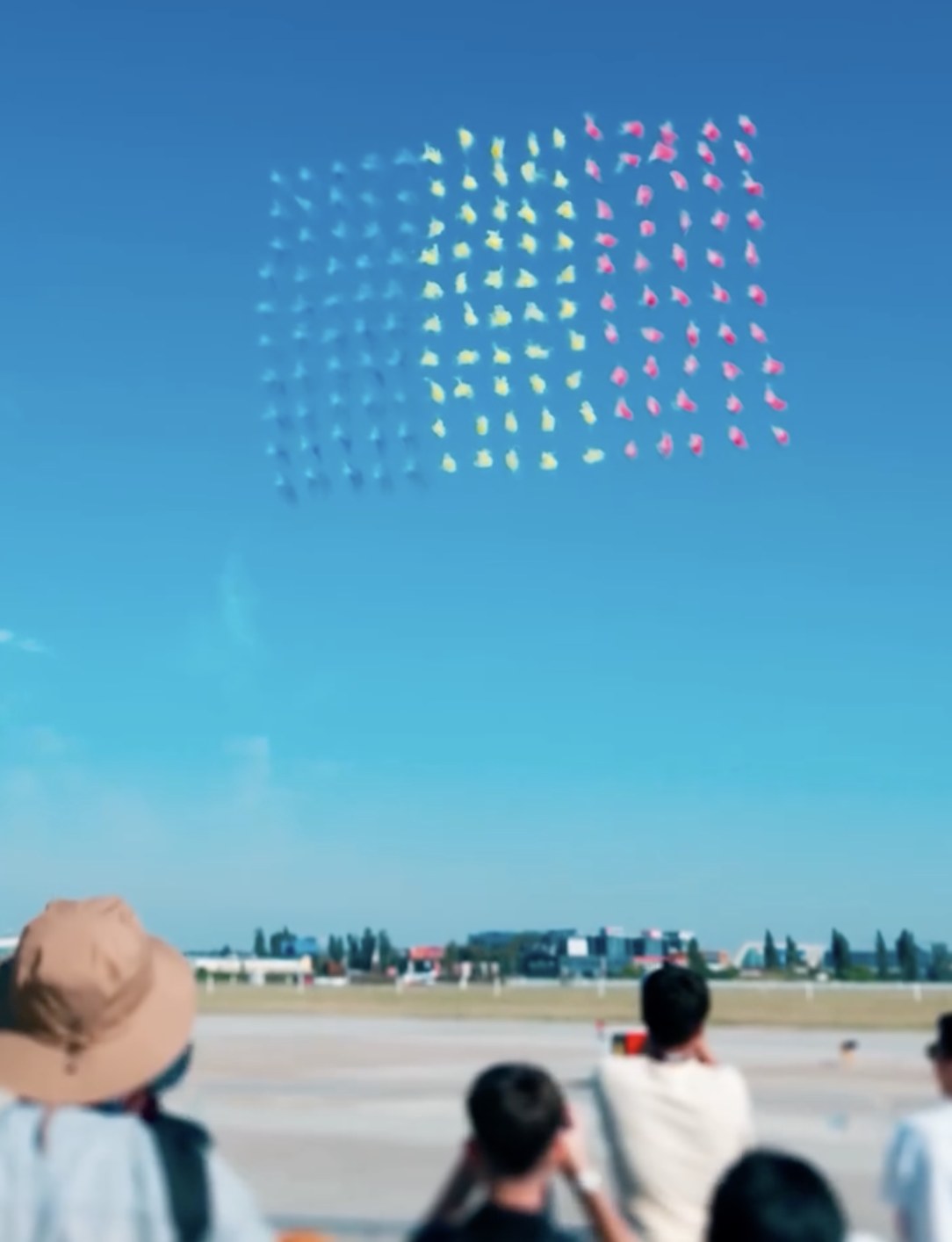 Hundreds of pyrotechnic drones forming the Romanian flag above the crowd at BIAS 2026, Baneasa Airport
